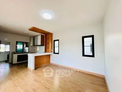 Spacious open-plan living area with modern kitchen and wooden flooring