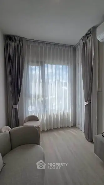 Elegant corner unit with floor-to-ceiling windows and plush seating in a modern living room.