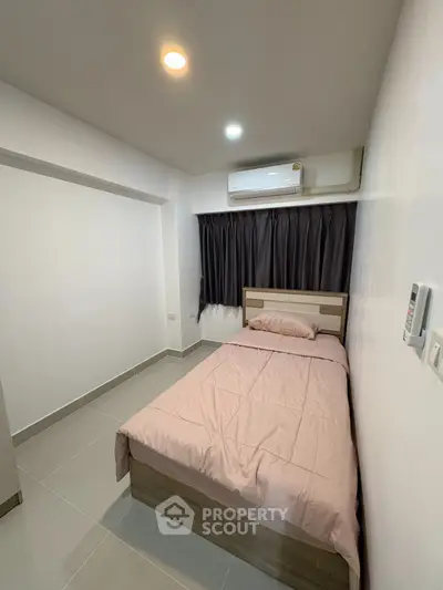 Cozy bedroom with modern air conditioning and sleek tile flooring