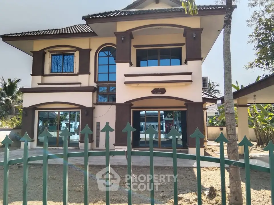 Stunning two-story house with large windows and elegant design, perfect for modern living.