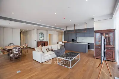 Spacious modern living room with open kitchen and elegant furnishings
