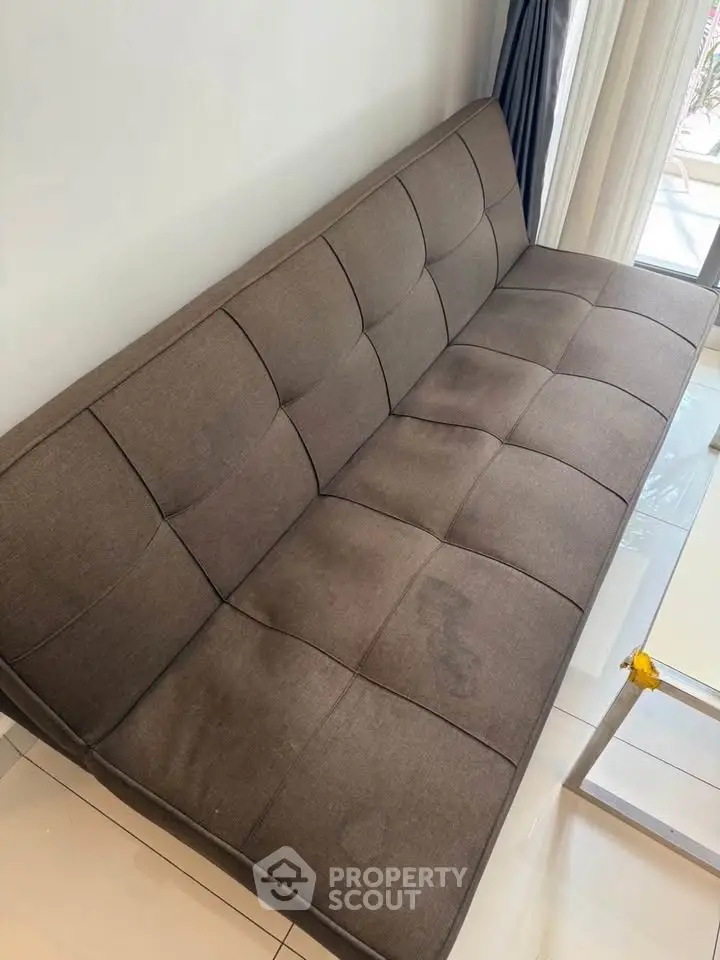 Modern brown sofa in a stylish living room with natural light