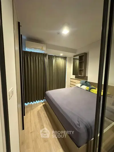 Modern bedroom with sleek design and ample natural light, featuring a comfortable bed and stylish decor.