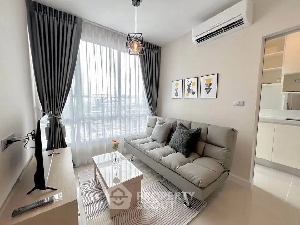 Modern living room with stylish decor, large window, and sleek furniture in a contemporary apartment.