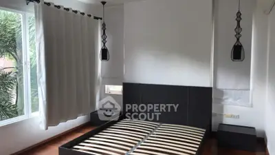 Spacious bedroom with modern design and large windows for natural light