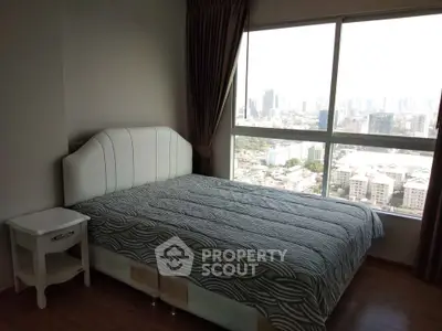 Spacious bedroom with city view and large window in modern apartment
