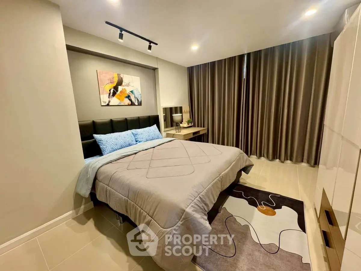 Modern bedroom with stylish decor and cozy ambiance in a contemporary apartment.