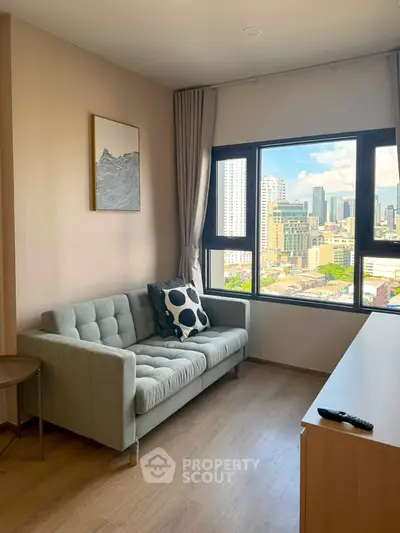 Modern living room with city view, featuring a stylish sofa and large window.