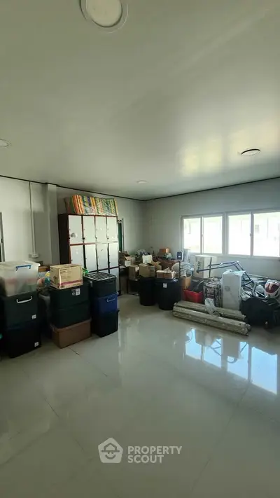 Spacious storage room with ample natural light and organized shelving.