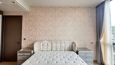 Luxurious bedroom with elegant wallpaper and plush bed in modern apartment