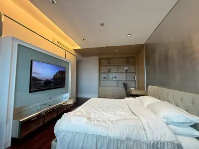 Luxurious bedroom with modern TV setup and elegant decor