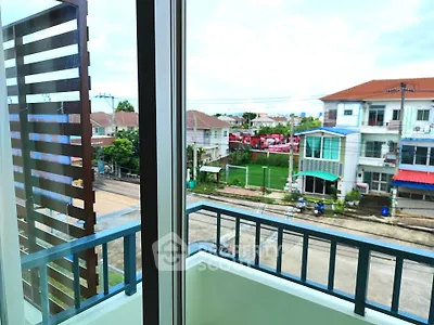 Charming balcony view of suburban neighborhood with modern houses and lush greenery.
