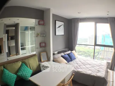 Modern studio apartment with panoramic city view and cozy interior design.