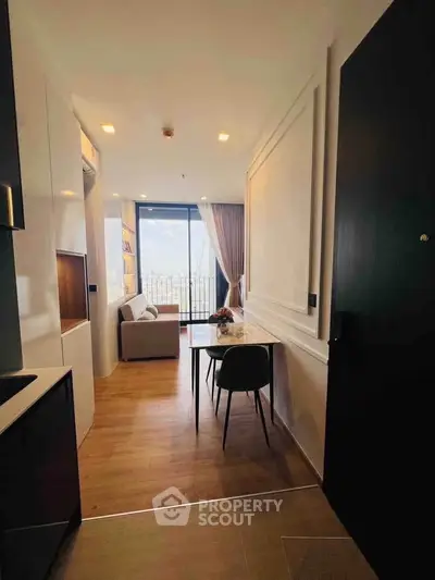 Modern apartment interior with open layout and city view, featuring stylish furniture and natural light.