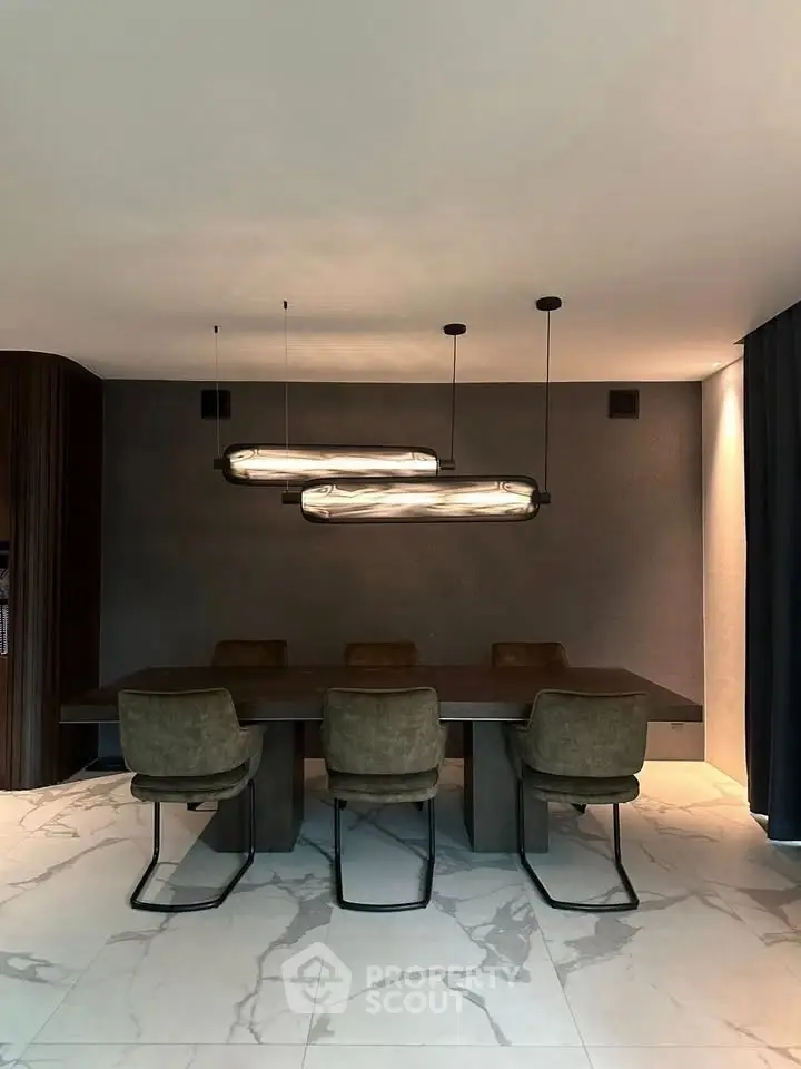 Modern dining room with elegant lighting and stylish chairs on marble flooring