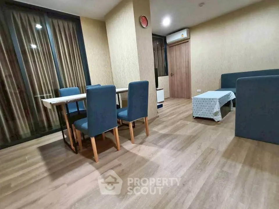 Spacious modern living room with elegant dining area and stylish furnishings.