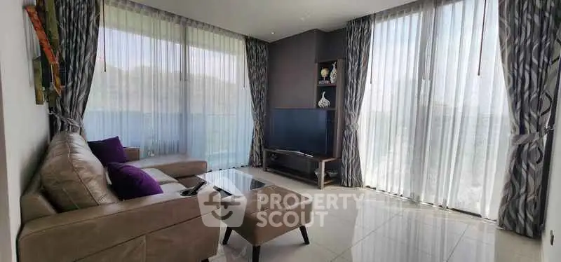 Spacious living room with modern decor and large windows for natural light.