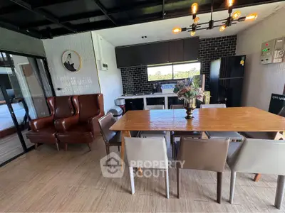 Modern open-layout kitchen and dining area with stylish decor and natural light.