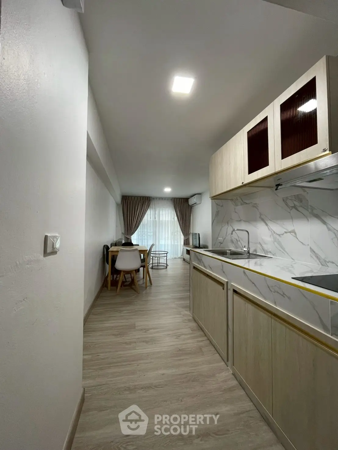 Modern kitchen with sleek design and open layout leading to dining area