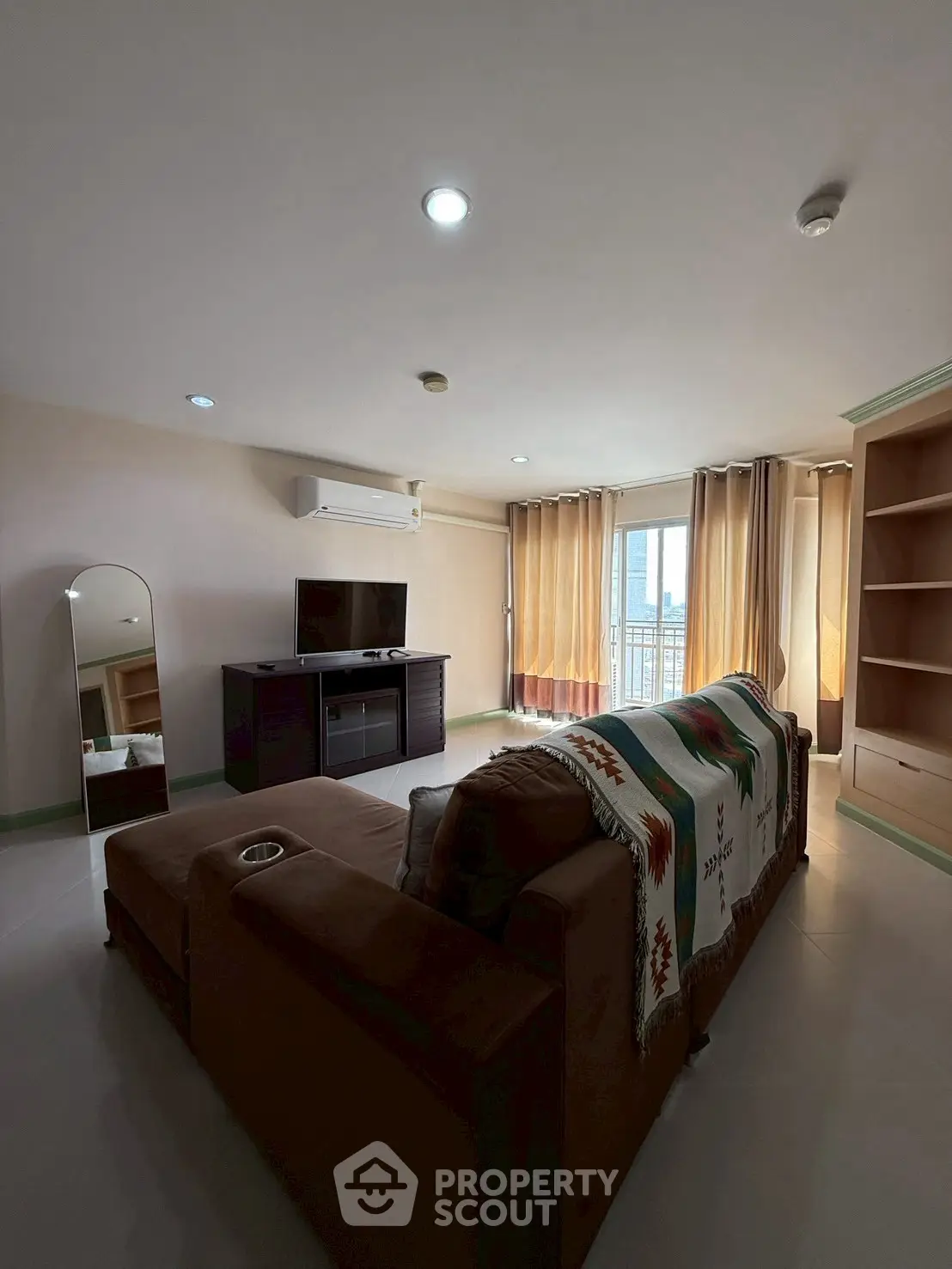 Spacious living room with modern furniture and city view