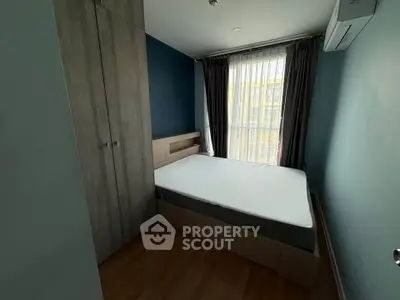 Cozy bedroom with modern design, featuring a comfortable bed and ample natural light through large windows.