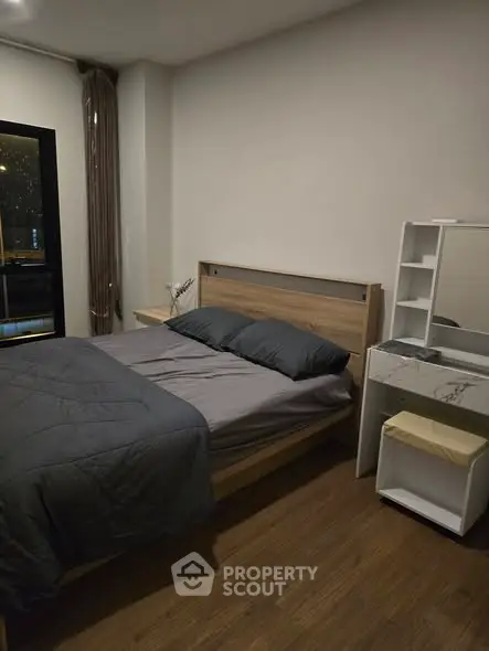 Cozy bedroom with modern wooden furniture and elegant decor in a stylish apartment.