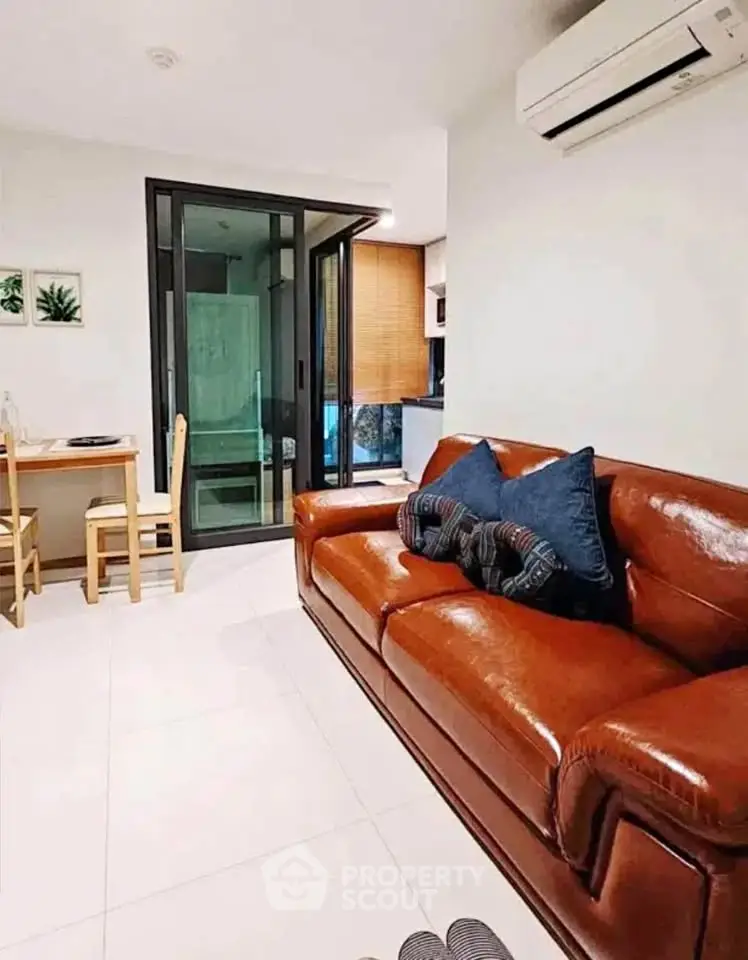 Modern living room with leather sofa and air conditioning in stylish apartment