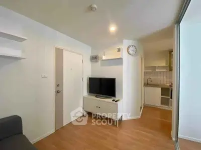 Modern living room with sleek TV unit and open kitchen layout