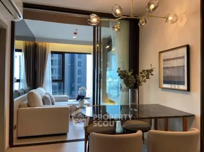 Modern living room with elegant decor and large windows in a stylish apartment.