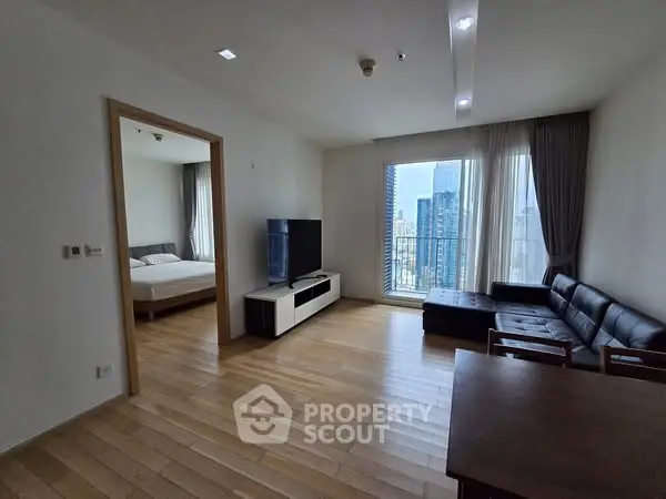 Modern apartment living room with city view and wooden flooring