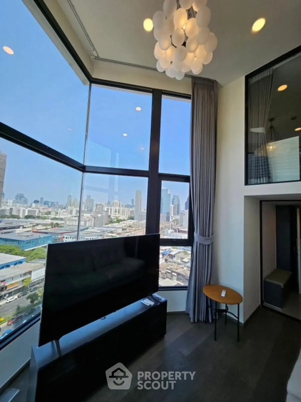 Stunning corner unit living room with panoramic city view and modern decor