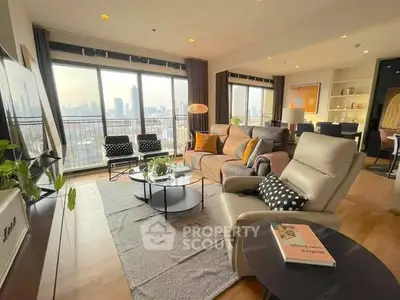 Spacious living room with city view, modern furniture, and natural light.