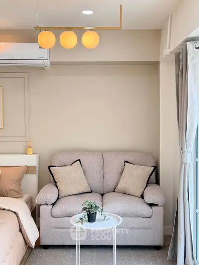 Cozy living room with modern sofa and elegant lighting, perfect for relaxation and comfort.