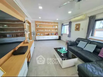 Spacious living room with modern decor and large windows for natural light.