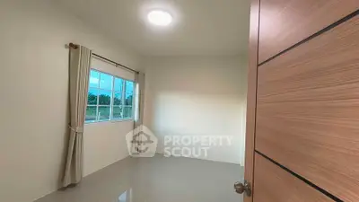 Spacious empty room with large window and modern flooring