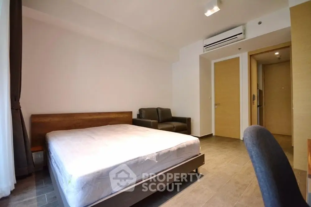 Modern bedroom with minimalist design and air conditioning in a stylish apartment.