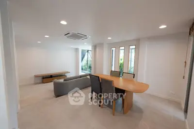 Spacious modern living room with elegant dining area and natural light