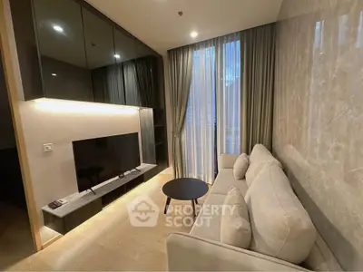Modern living room with sleek design, large TV, and floor-to-ceiling windows for natural light.