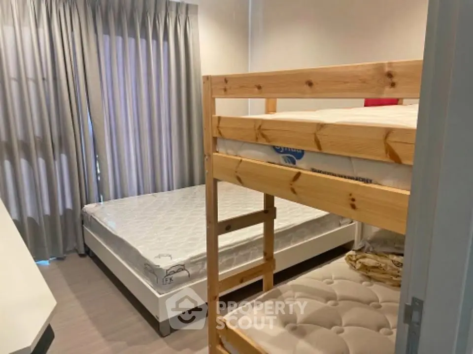 Cozy bedroom with bunk bed and double bed, ideal for family living.