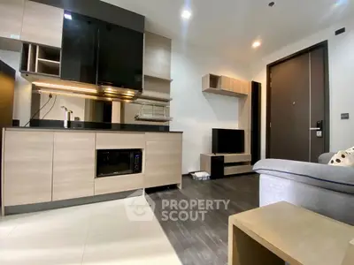 Modern living room with sleek kitchen and stylish decor