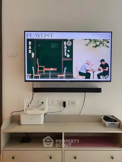 Modern living room with wall-mounted TV and sleek entertainment unit