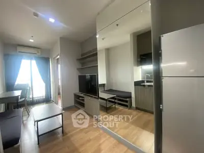 Modern living room with sleek furniture and open kitchen layout in a stylish apartment.