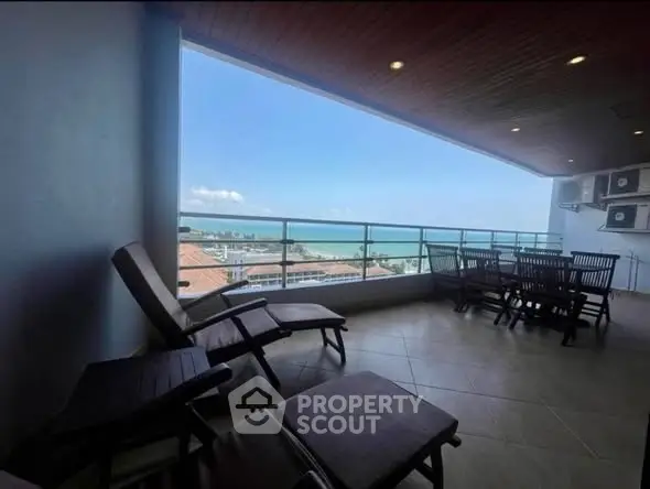 Spacious balcony with stunning ocean view, perfect for relaxation and outdoor dining.