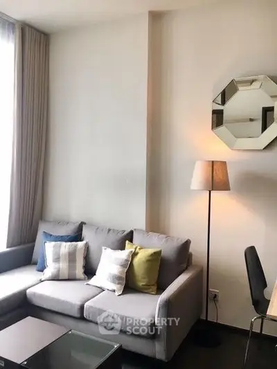 Modern living room with stylish decor and comfortable seating in a bright apartment.