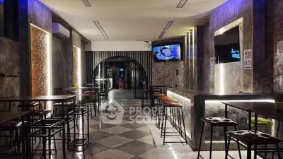 Modern bar interior with stylish lighting and high-top tables