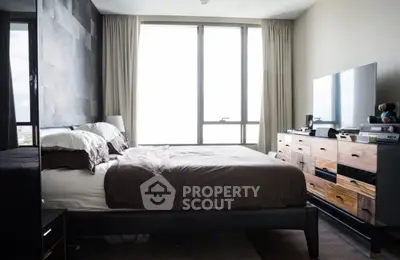 Modern bedroom with large window and stylish furniture