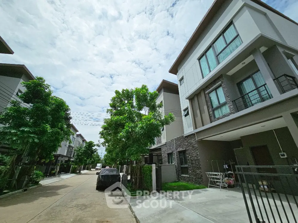 Modern townhouse complex with lush greenery and spacious driveways