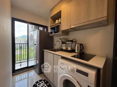 Modern kitchen with appliances and balcony view in a stylish apartment