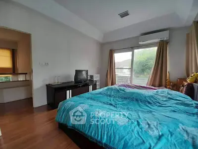 Spacious bedroom with balcony access and modern amenities