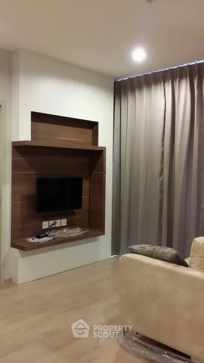 Modern living room with sleek TV setup and elegant curtains